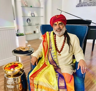 Guruji Sri Sadashiva Subramaniya Swamy seated in traditional attire